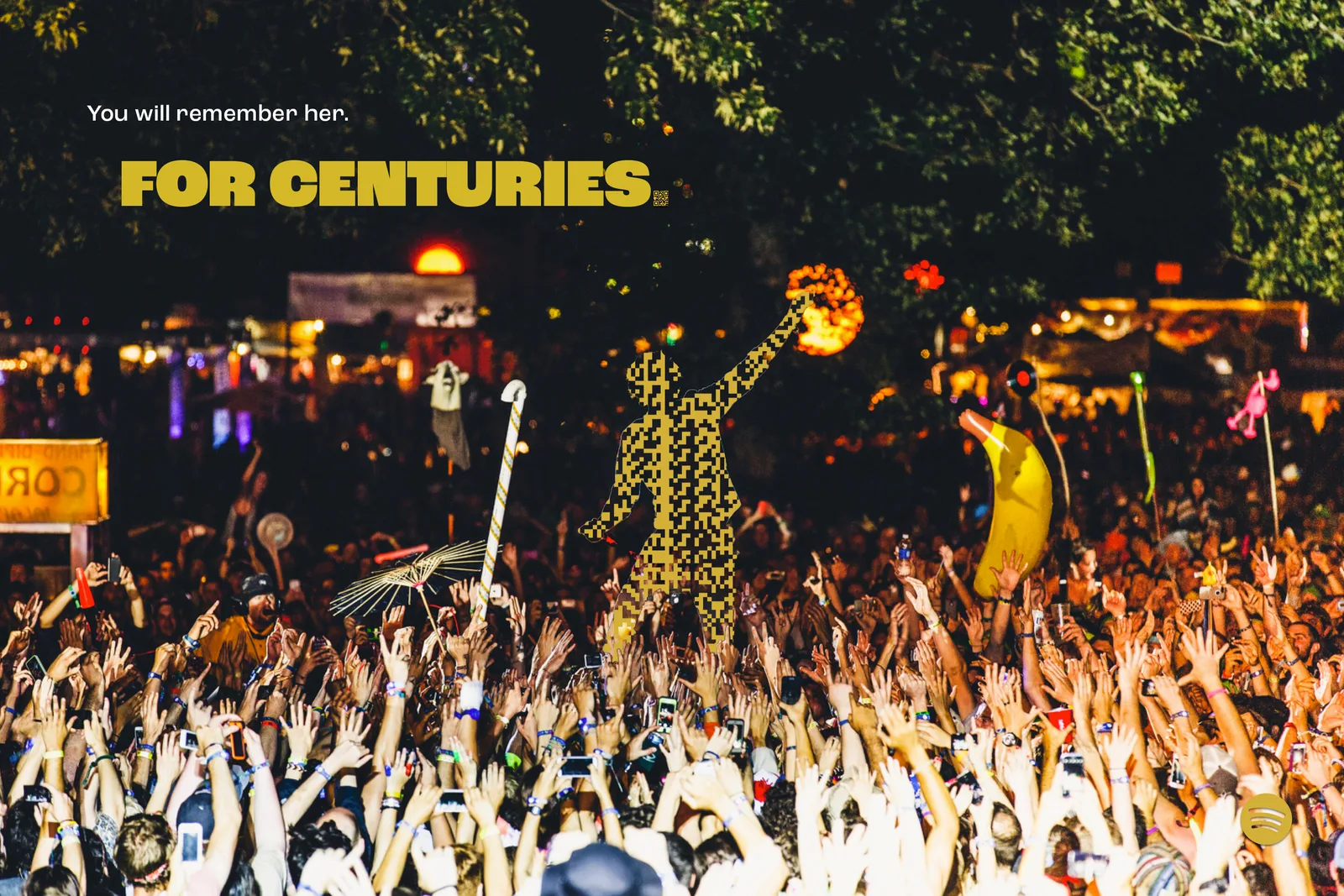 Night festival with inflatables, a gold code figure on shoulders. Headline, You will remember her. For centuries.