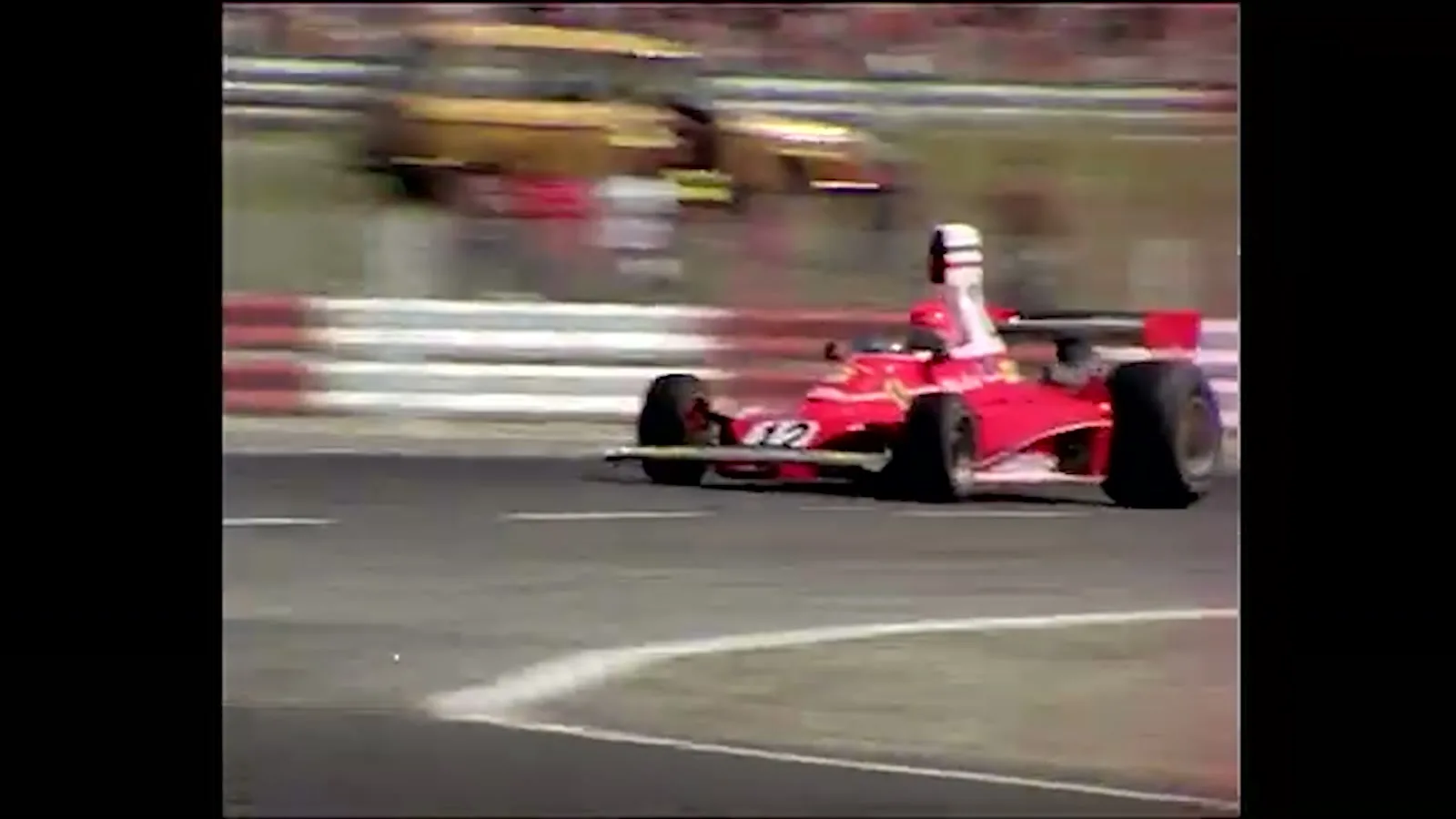 Archive footage frame of Niki Lauda's Ferrari 312T, number 12, pillarboxed