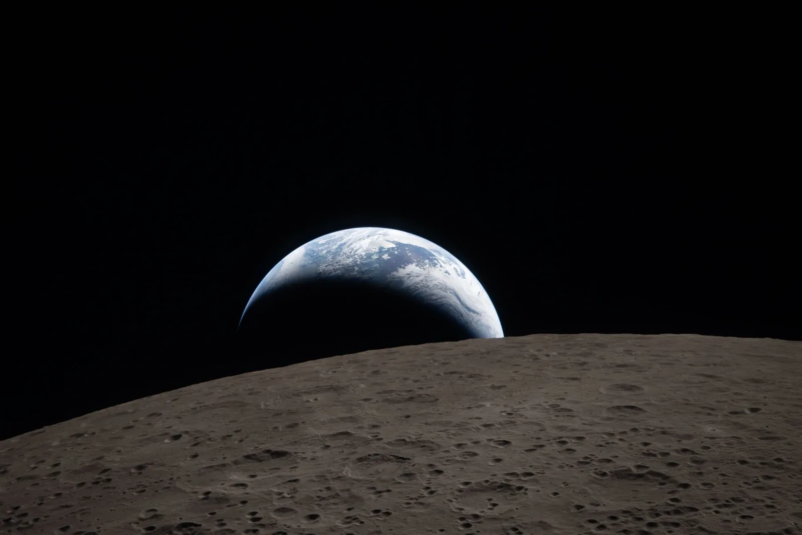 Earth setting behind the lunar horizon, photographed from Artemis II